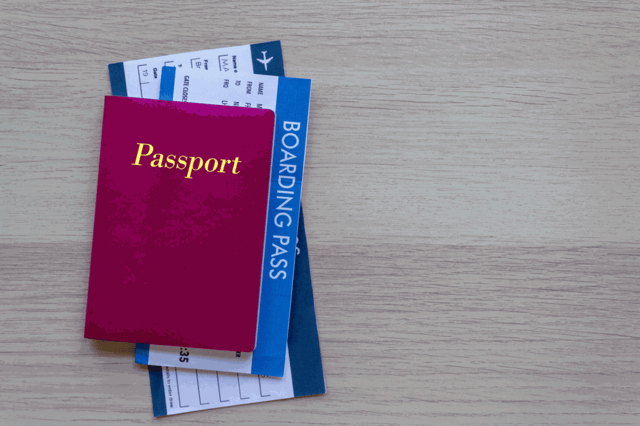 Passport and boarding pass on wood table