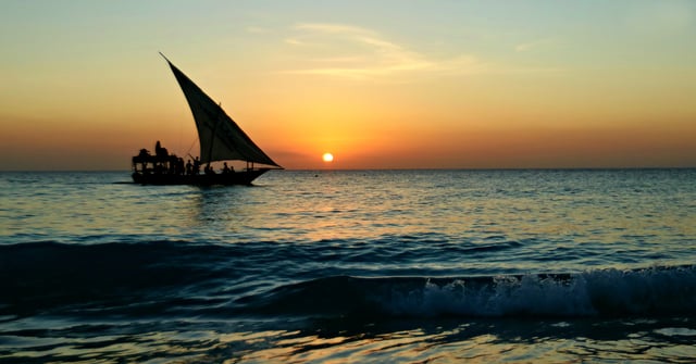 Dhow Cruising By The Beach With Sunset