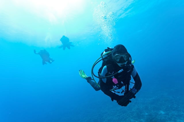 Female Scuba Diver Underwater Swimming