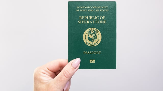 Hand holding Sierra Leone passport