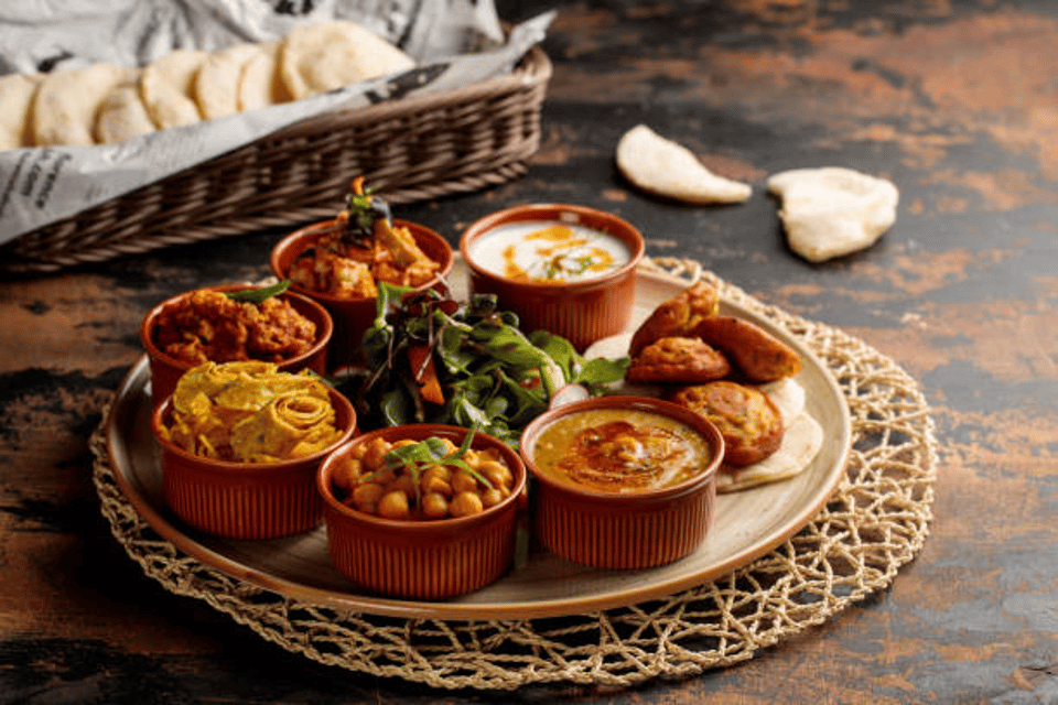 Bahraini Breakfast set with hummus, raita, salad, gravy, vegetable and bread served in dish isolated on table top view of arabic breakfast
