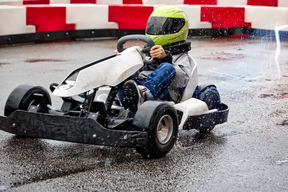 Child Enjoying Go Karting In Rain