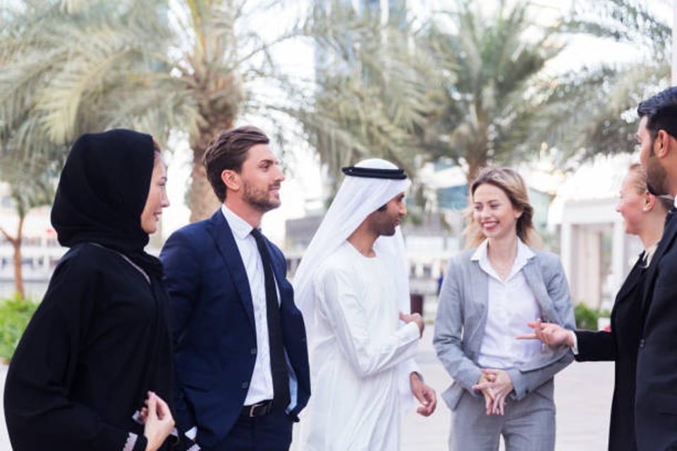 Foreign entrepreneurs work with an Emirati businessman in the Middle East